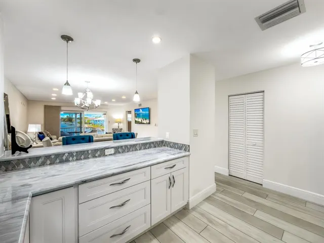 a spacious bathroom with a granite countertop sink a mirror and a shower