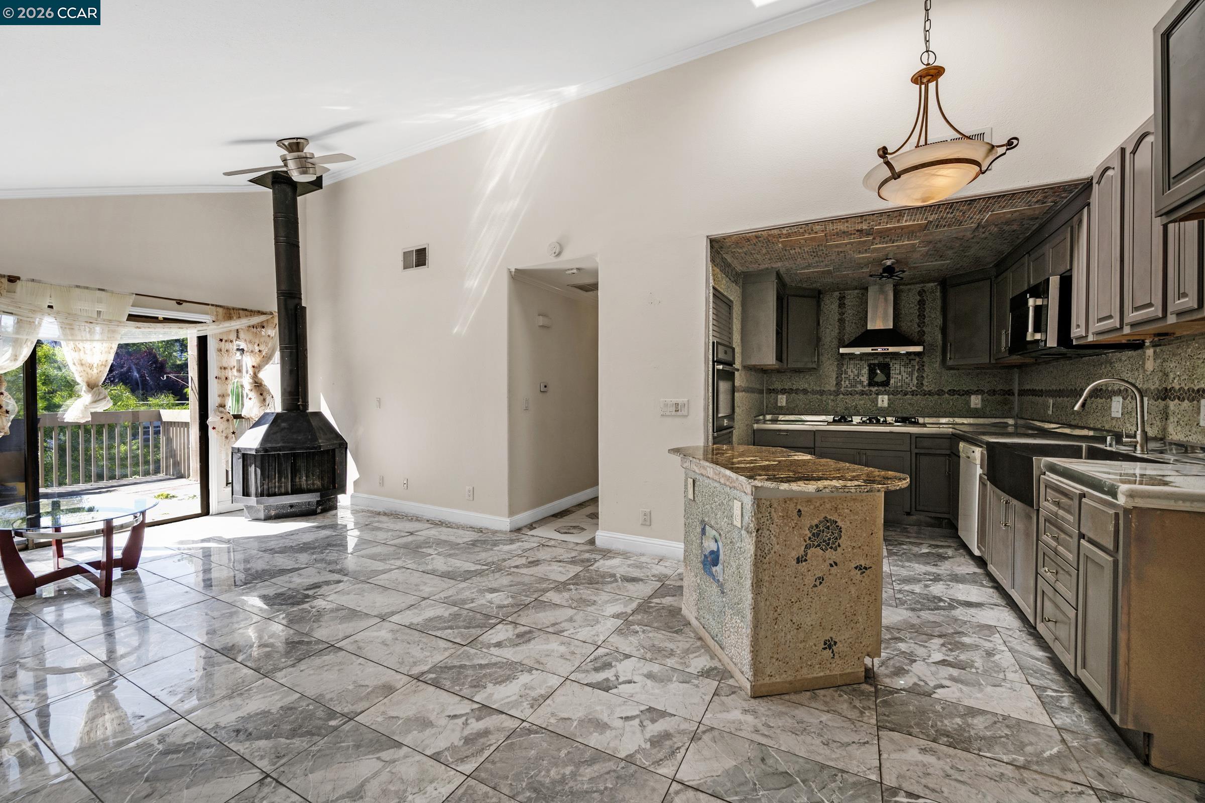 1544 Bailey Road, Unit 30 Concord, CA 94521 - Photo 5 of 33 a kitchen with kitchen island granite countertop a stove a sink and a refrigerator