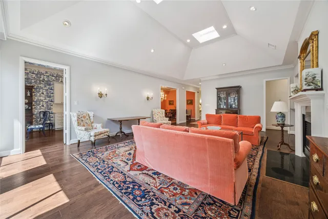 a living room with furniture a fireplace and a dining table