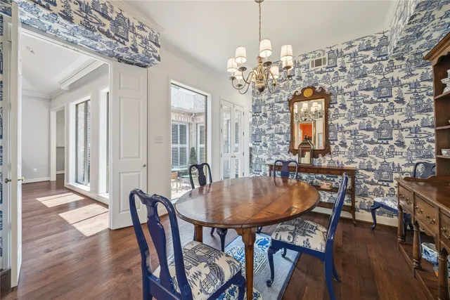 a view of a dining room with furniture wooden floor and chandelier