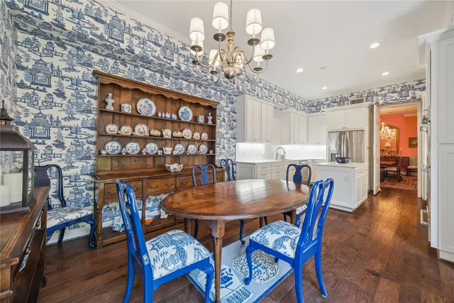 a view of a dining room with furniture wooden floor and chandelier