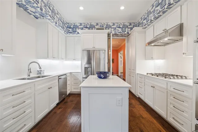 a kitchen with a sink stove and refrigerator