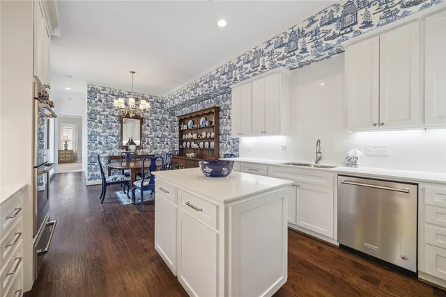 a kitchen with a sink a center island and cabinets