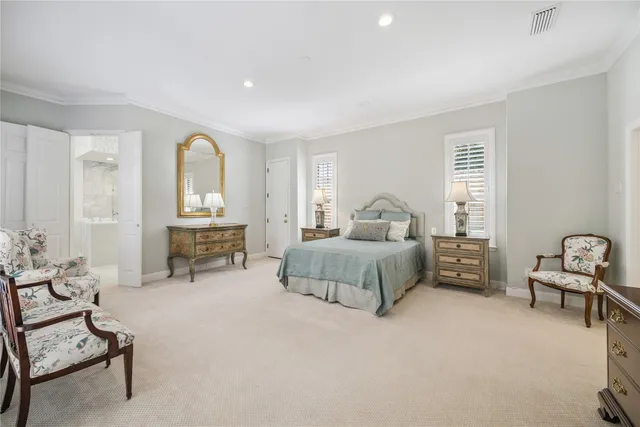 a spacious bedroom with a bed and a chandelier