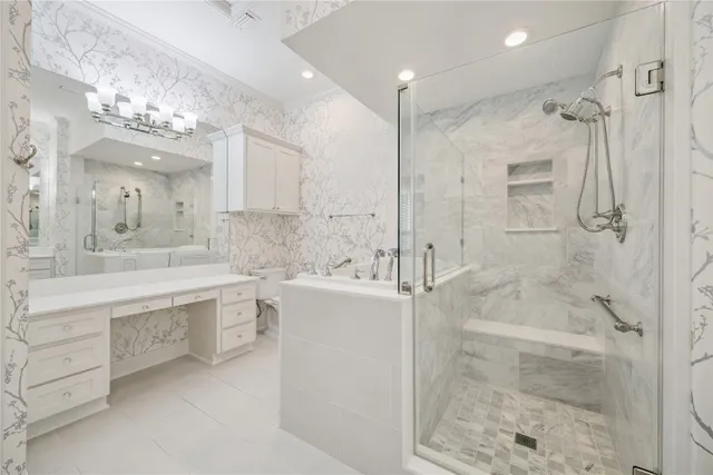 a bathroom with a bathtub shower sink vanity and mirror