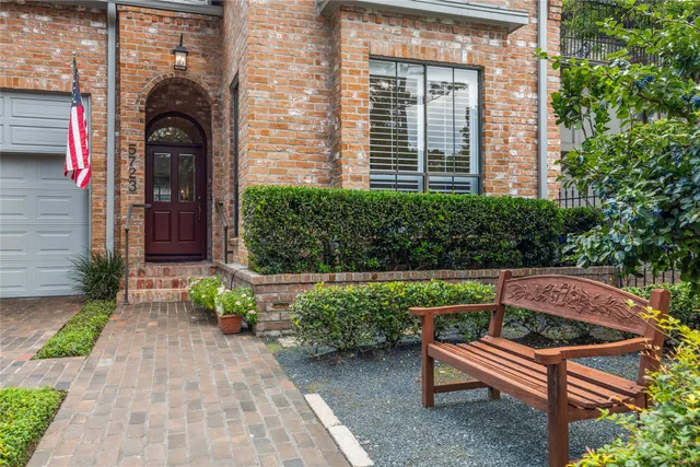 a view of a bench sitting in back yard of the house