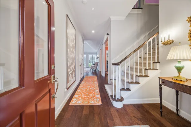 a view of entryway and hall with wooden floor