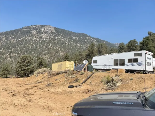 a view of a house with a snow in the background