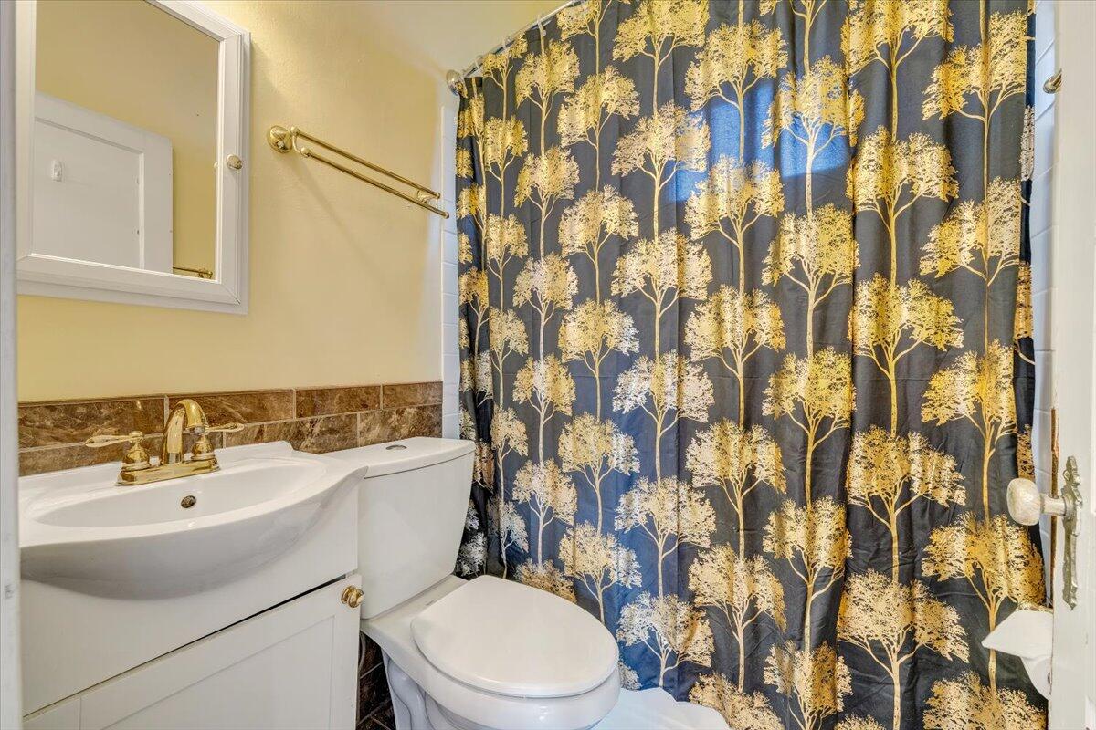 3116 Spring Road Southwest Roanoke, VA 24015 - Photo 13 of 22 a bathroom with a sink toilet and shower