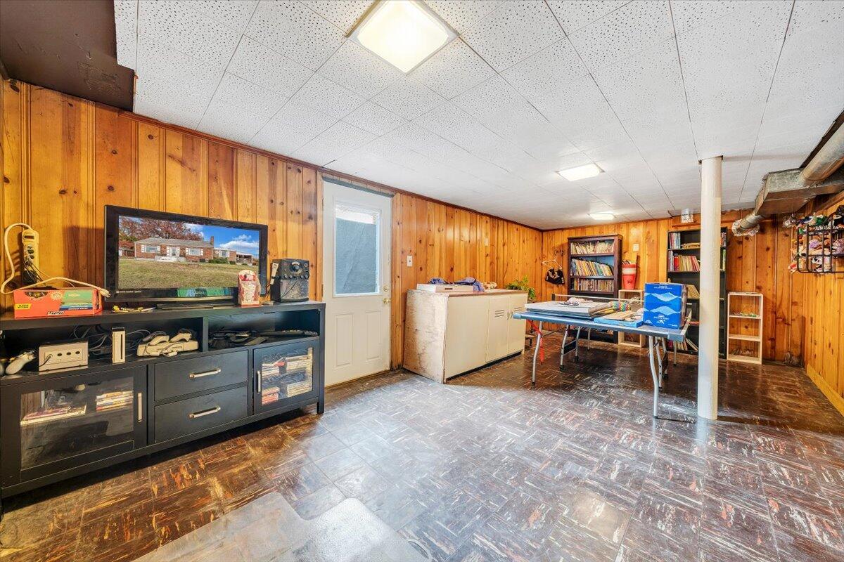 3116 Spring Road Southwest Roanoke, VA 24015 - Photo 16 of 22 a living room with a flat screen tv and furniture