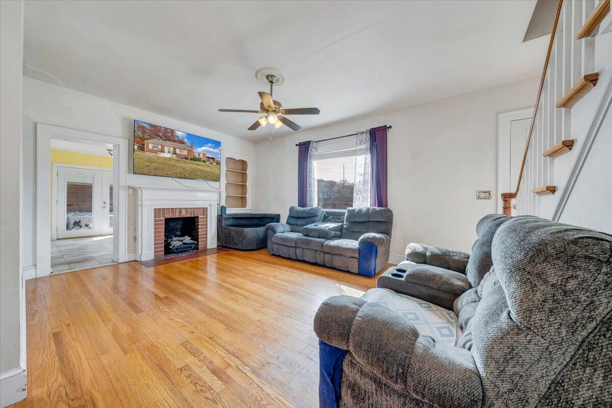 3116 Spring Road Southwest Roanoke, VA 24015 - Photo 4 of 22 a living room with furniture a fireplace and a flat screen tv
