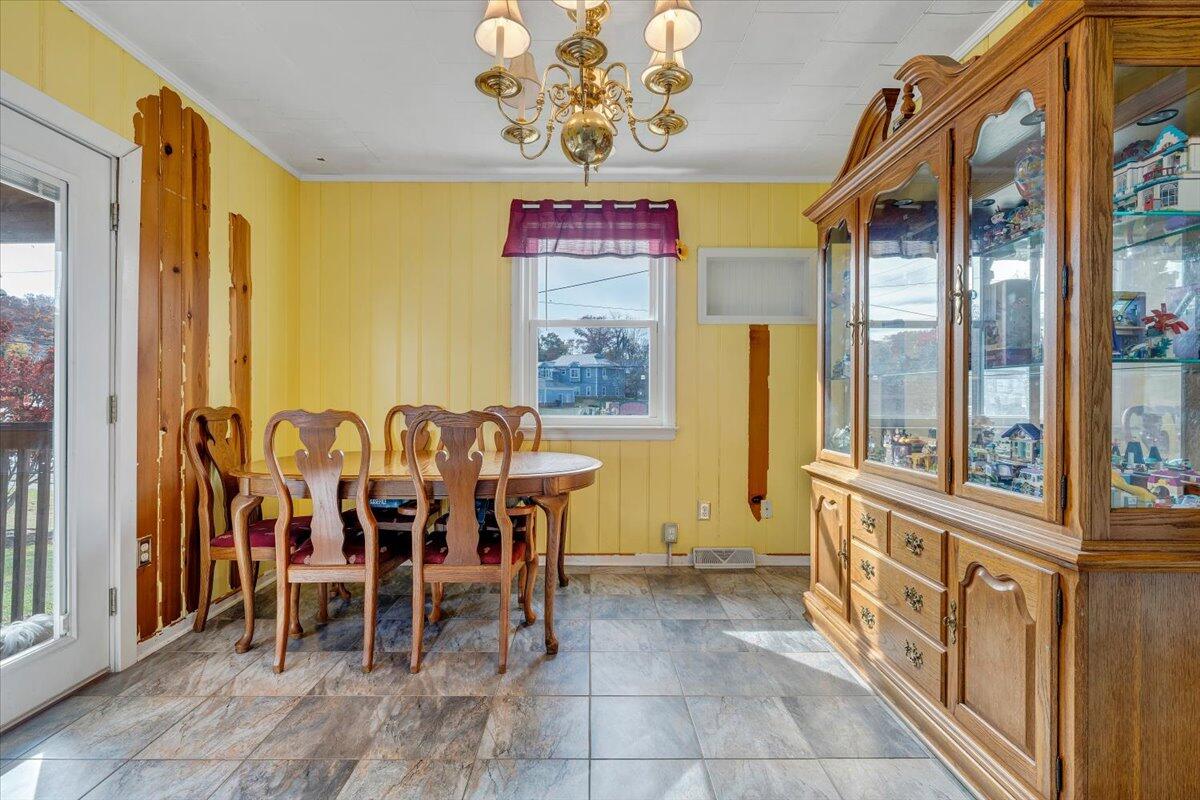 3116 Spring Road Southwest Roanoke, VA 24015 - Photo 5 of 22 a view of a dining room with furniture window and outside view
