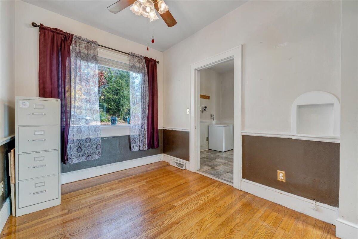 3116 Spring Road Southwest Roanoke, VA 24015 - Photo 8 of 22 wooden floor in an empty room with a window