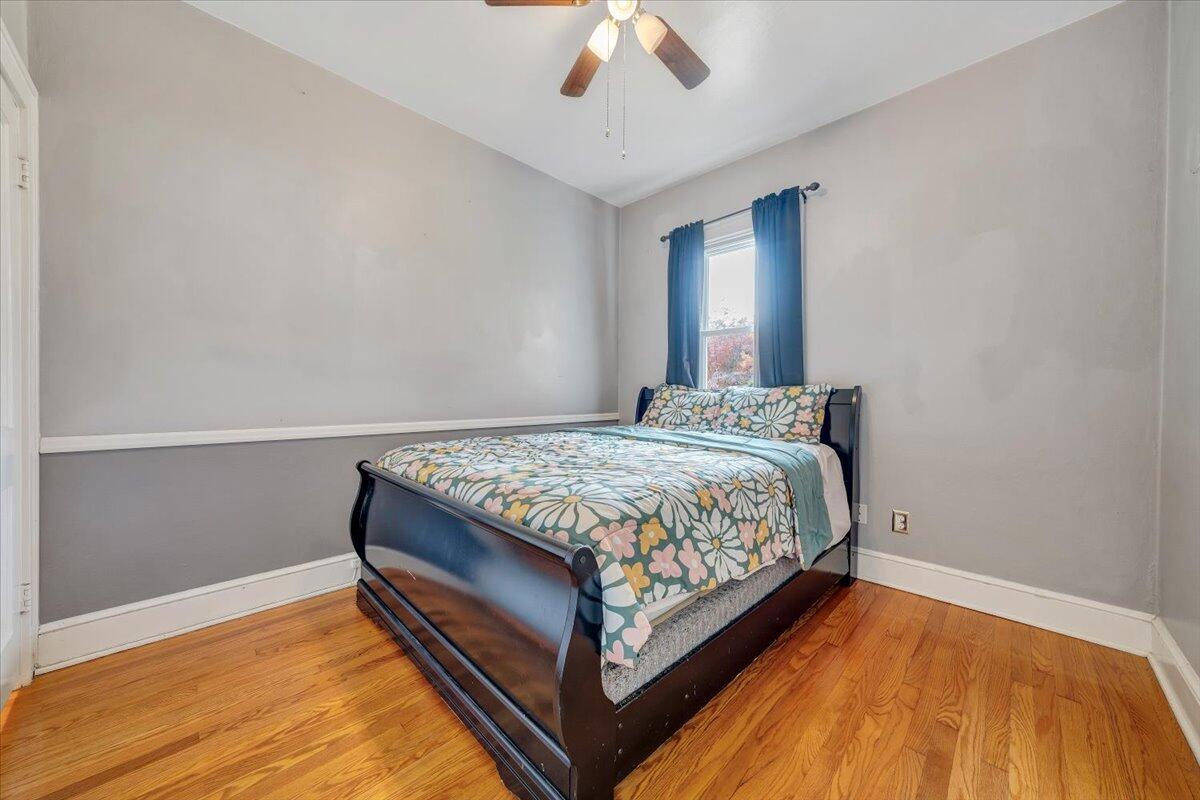 3116 Spring Road Southwest Roanoke, VA 24015 - Photo 9 of 22 a bedroom with a bed and a chandelier