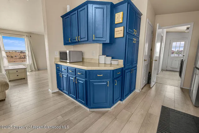 a kitchen with granite countertop a stove and cabinets