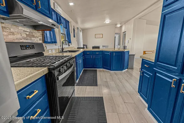 a kitchen with a sink stove and cabinets
