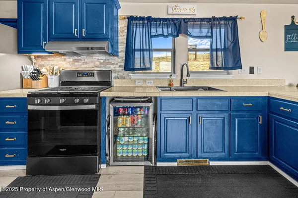 a kitchen with stainless steel appliances granite countertop wooden cabinets a stove top oven a sink and dishwasher