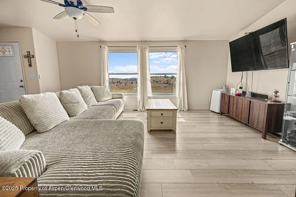 a living room with a bed furniture and next to a window