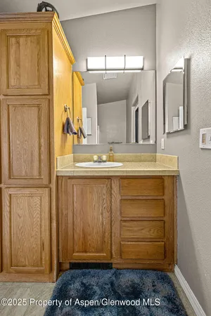 a bedroom with furniture and a mirror