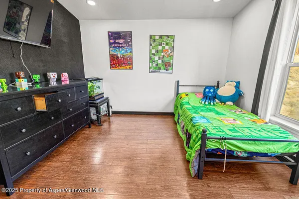 a view of a workspace with furniture and a flat screen tv