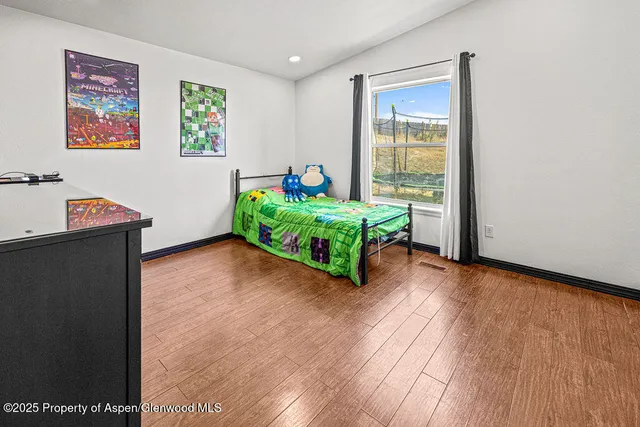 a view of a workspace with furniture and a flat screen tv