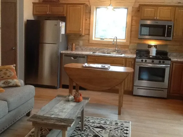 a kitchen with stainless steel appliances granite countertop a refrigerator stove and sink