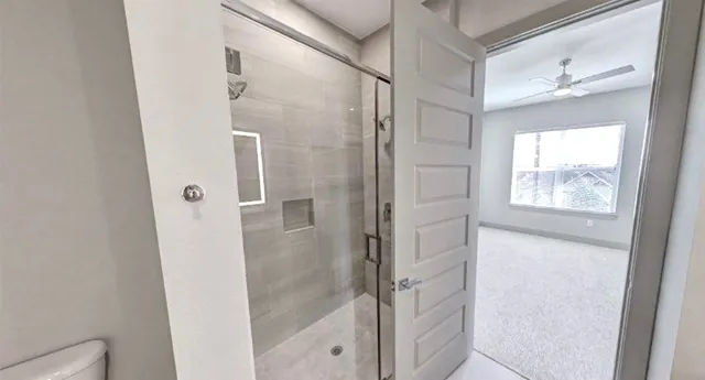 a bathroom with a glass shower door