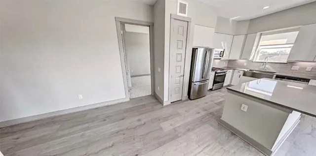 a kitchen with stainless steel appliances a refrigerator and a stove