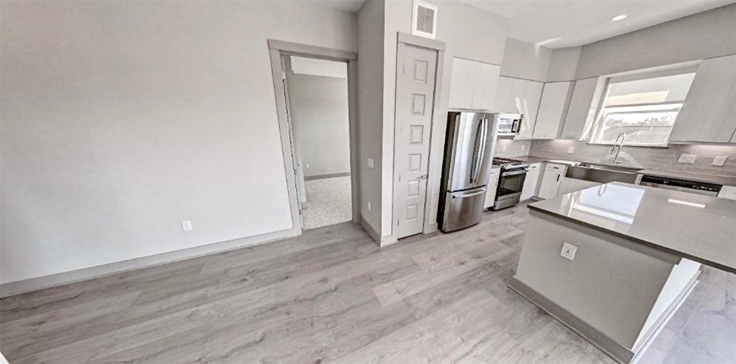 401 West 25th Street, Unit 1144 Houston, TX 77008 - Photo 5 of 42 a kitchen with stainless steel appliances a refrigerator and a stove