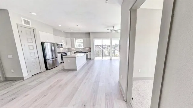 a kitchen with a refrigerator a sink and cabinets