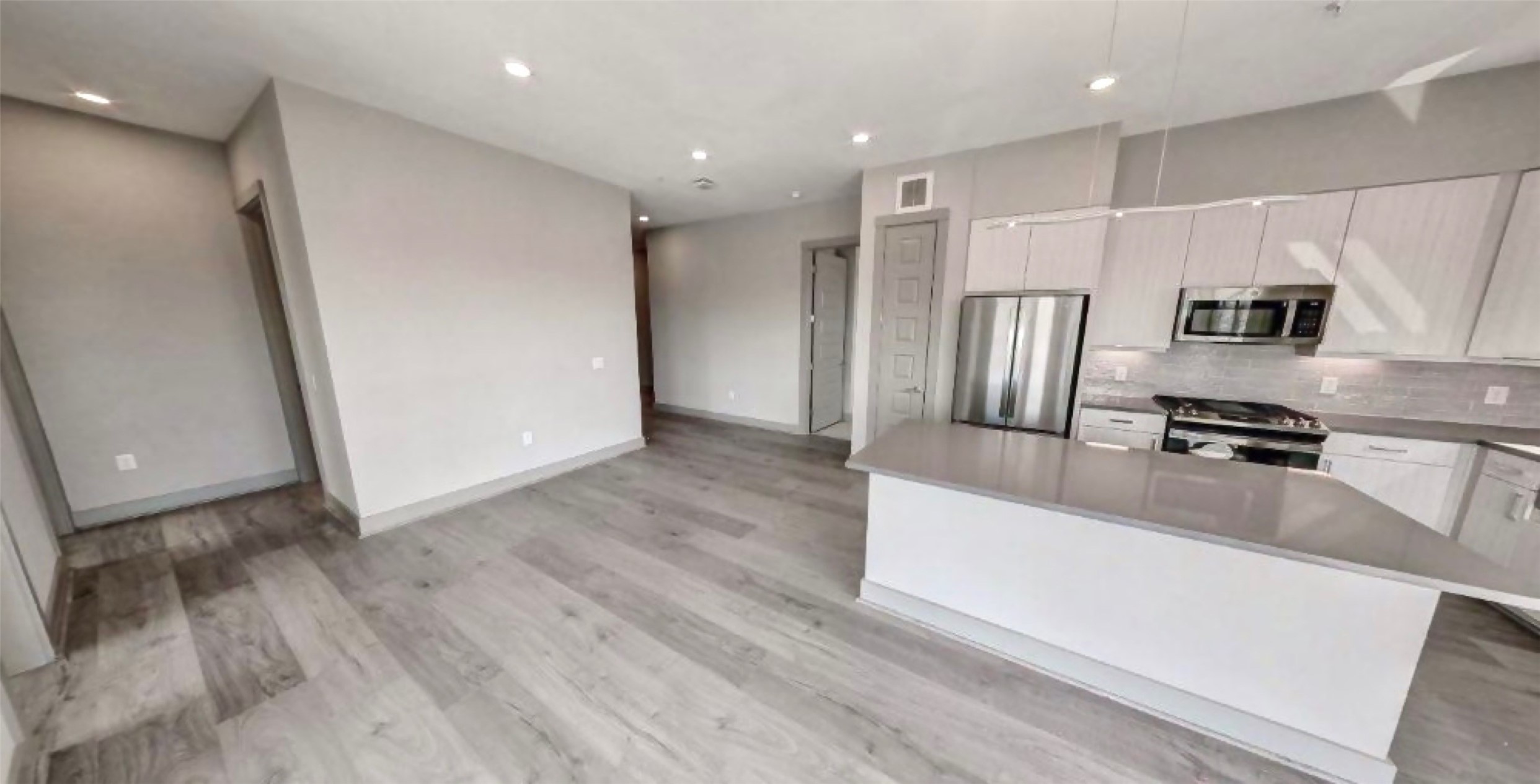 401 West 25th Street, Unit 1144 Houston, TX 77008 - Photo 7 of 42 a kitchen with stainless steel appliances a refrigerator and a stove top oven