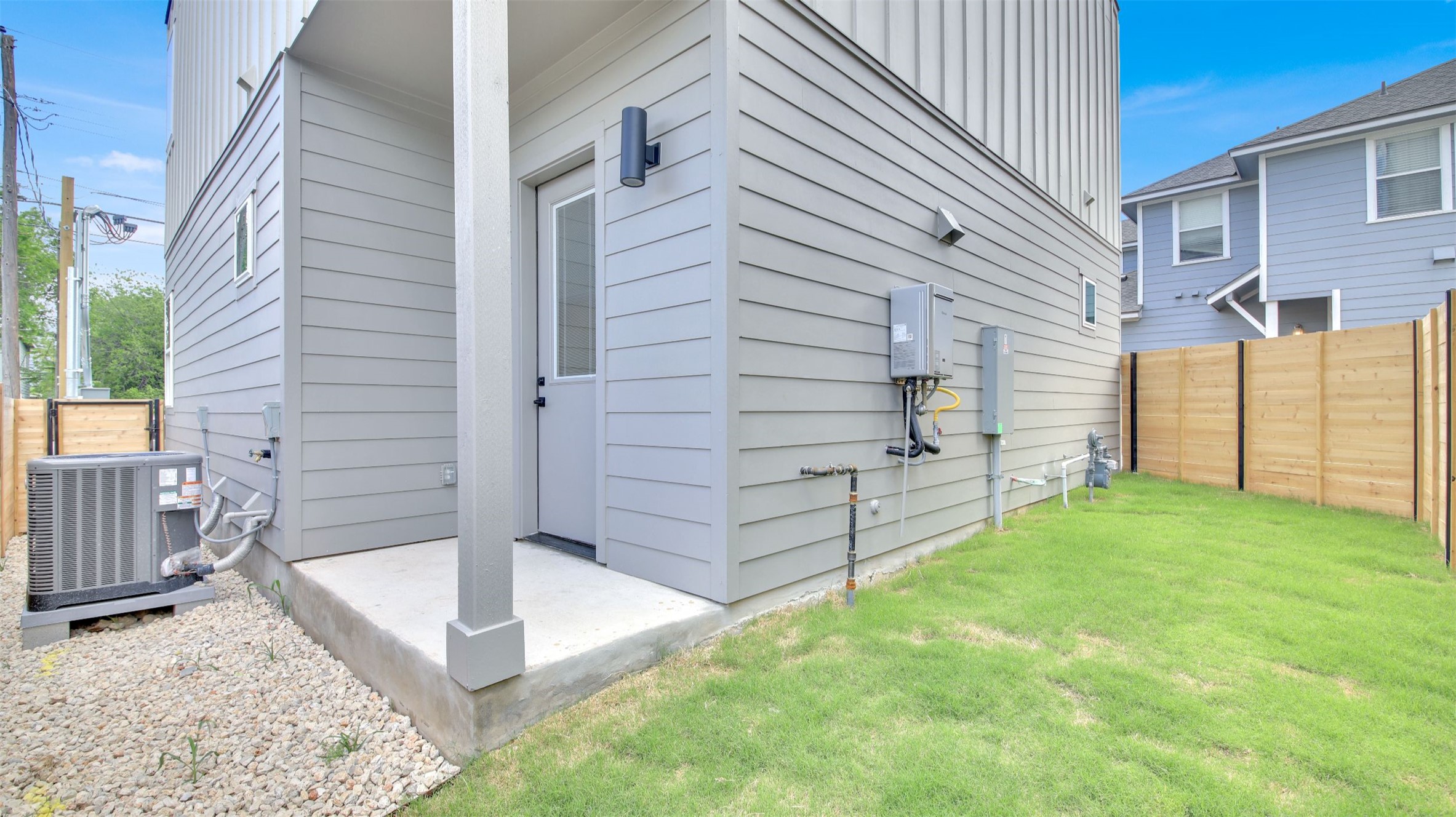 7208 Providence Avenue, Unit 1 Austin, TX 78752 - Photo 25 of 26 The property features a private lawn area, a paved patio, and light gray siding