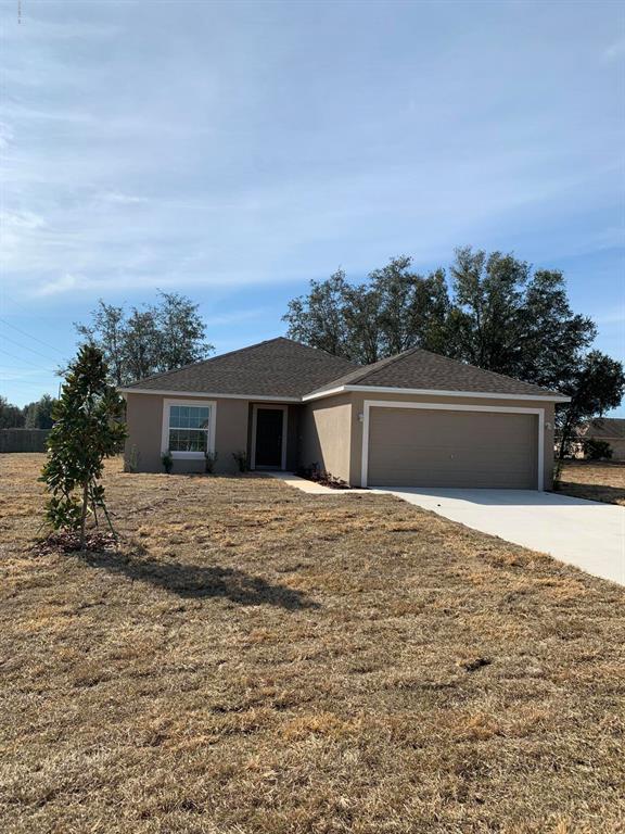 4776 Southwest 138 Loop Ocala, FL 34473 - Photo 1 of 1 a house with trees in the background