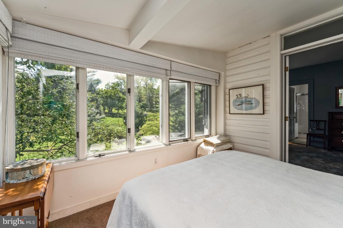 1807 Kenway Road Baltimore, MD 21209 - Photo 20 of 54 a bedroom with a large bed and large windows