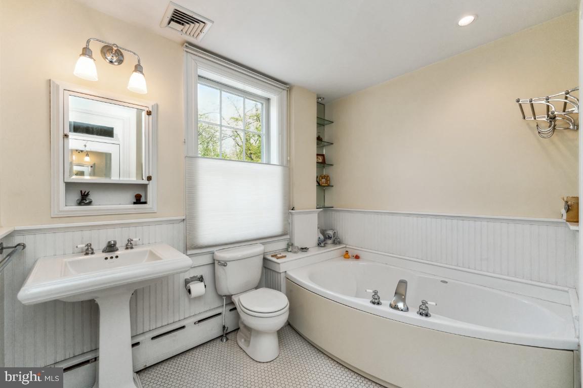 1807 Kenway Road Baltimore, MD 21209 - Photo 22 of 54 a bathroom with a sink mirror and a bathtub