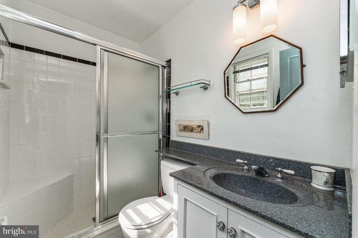 1807 Kenway Road Baltimore, MD 21209 - Photo 25 of 54 a bathroom with a sink a toilet and a mirror