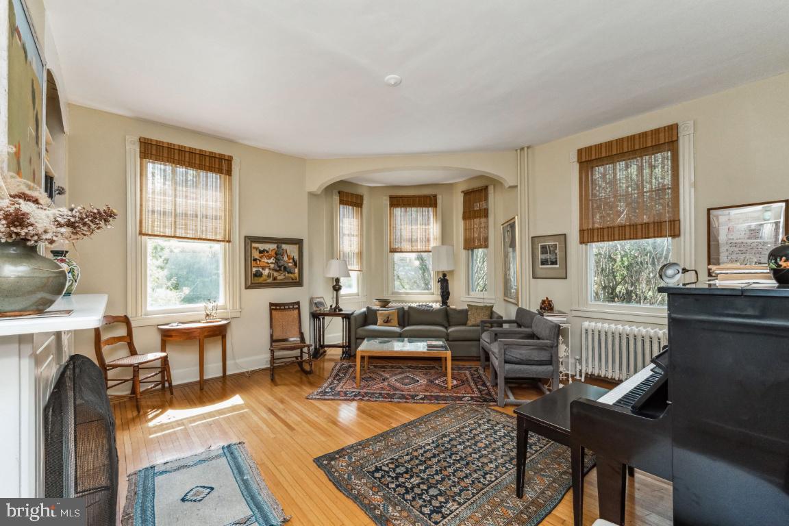 1807 Kenway Road Baltimore, MD 21209 - Photo 7 of 54 a living room with furniture a fireplace and large windows