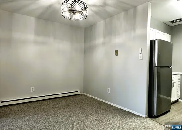 a view of a refrigerator in kitchen
