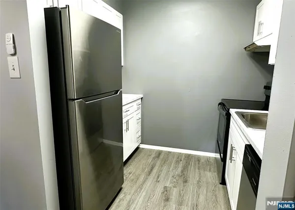 a view of a storage and utility room with washer and dryer