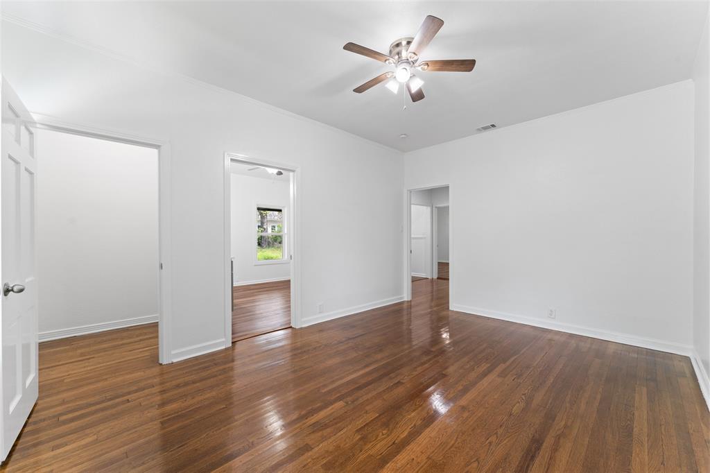 2405 Monroe Street Commerce, TX 75428 - Photo 20 of 31 an empty room with wooden floor and windows
