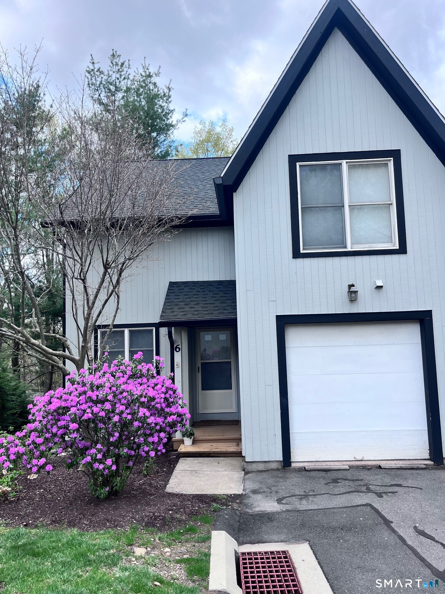 6 Timberline Drive, Unit 6 Farmington, CT 06032 - Photo 1 of 26 a front view of a house with a garden