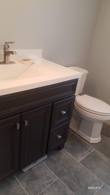 6 Timberline Drive, Unit 6 Farmington, CT 06032 - Photo 14 of 26 a bathroom with a toilet a sink and vanity