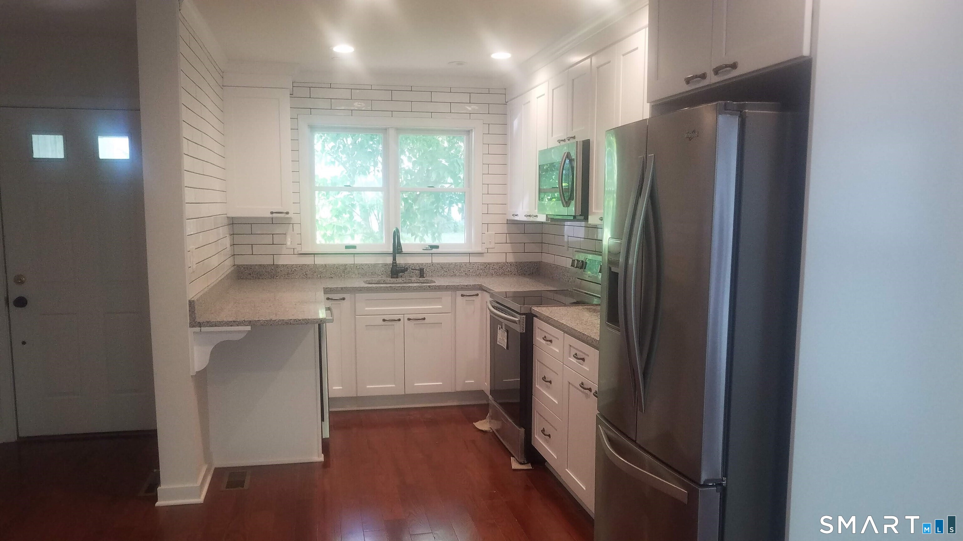 6 Timberline Drive, Unit 6 Farmington, CT 06032 - Photo 4 of 26 a kitchen with a refrigerator sink and cabinets