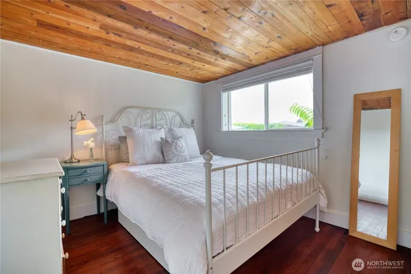 a bed sitting in a bedroom next to a window