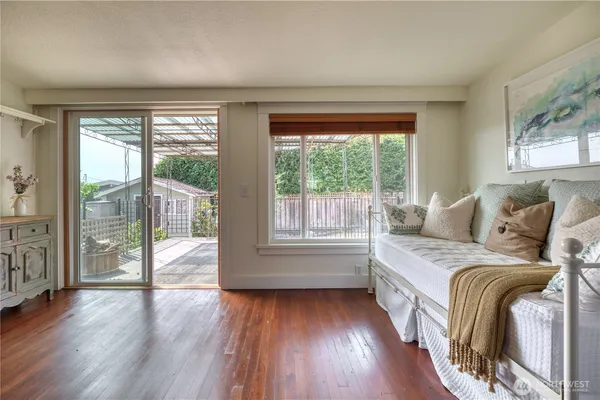 a spacious bedroom with a bed and wooden floor