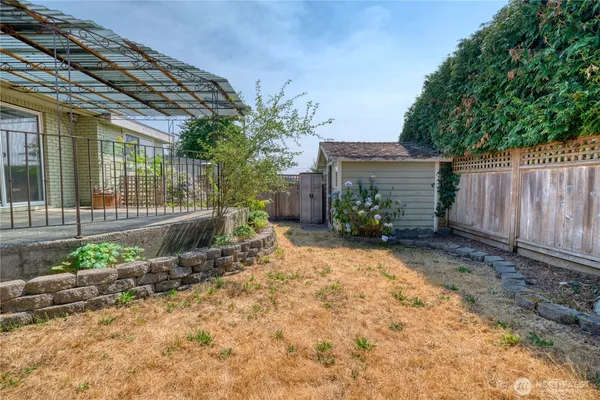 a view of a house with a backyard and a garage