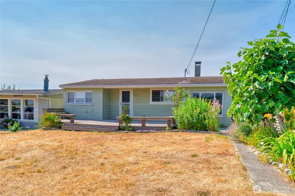 a front view of house with yard and outdoor seating