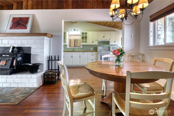 a living room with furniture a dining table and a fireplace