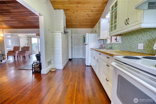 a kitchen with wooden floors and a sink