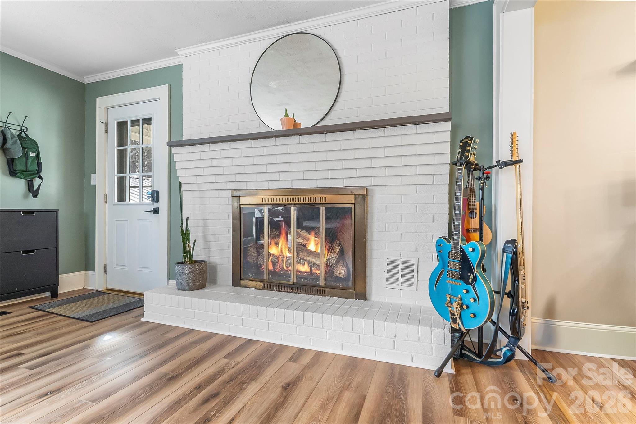 1072 5th Street Northeast Hickory, NC 28601 - Photo 2 of 33 an empty room with wooden floor a fireplace and a window